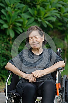 Smiling elderly woman ,sitting on wheelchair