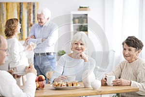 Smiling elderly women drinking tea