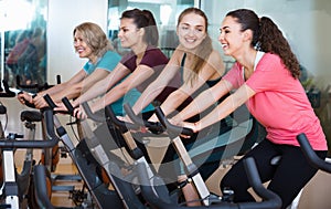 Smiling elderly and young women working out hard