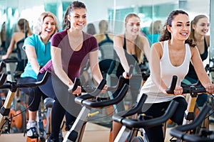 Smiling elderly and young women working out hard