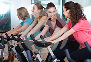 Smiling elderly and young women working out hard