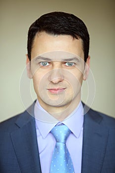 Smiling elegance brunet man in business suit with photo