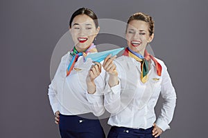 smiling elegant air hostess women isolated on grey