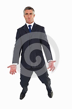 Smiling elegant businessman carrying something