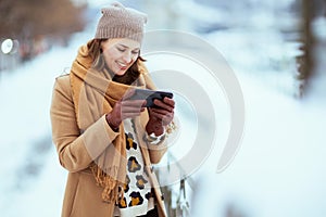 smiling elegant female using smartphone applications