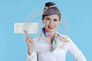 smiling elegant flight attendant woman on blue