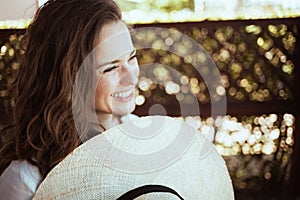 Smiling elegant housewife in white shirt with hat