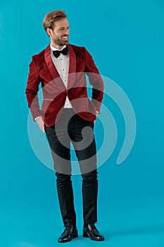 Smiling elegant man wearing red velvet tuxedo