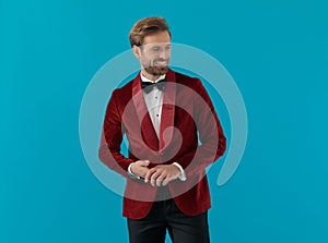 Smiling elegant man wearing red velvet tuxedo