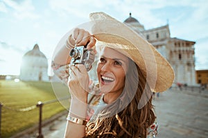 Smiling elegant solo tourist woman in floral dress