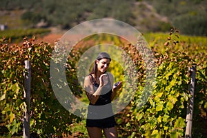 Smiling elegant woman in nature.Joy and happiness.Serene female in wine grape field in sunset.Wine growing field.Agricultural tour