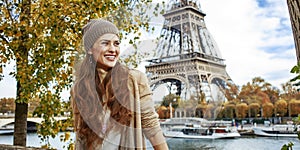 Smiling elegant woman tourist having excursion in Paris, France