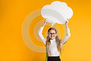 Smiling Elementary Student Girl Holding Speech Bubble Overhead, Studio Shot