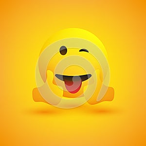 Smiling Emoticon on Yellow Background - Simple Happy Emoticon with Winked Eye and Outstretched Tongue Showing Thumbs Up photo