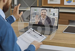 Smiling employer or hiring manager greeting job candidate in virtual job interview