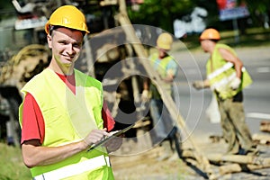 Smiling Engineer builder at road works site photo
