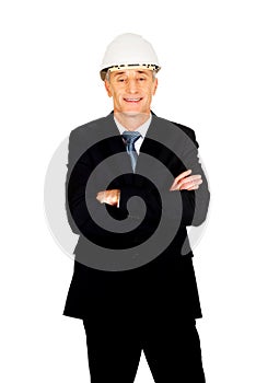 Smiling engineer with hard hat and folded arms