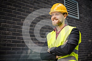 Smiling engineer standing on the street. Cloe up