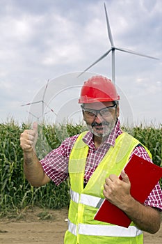 Smiling Engineer Wearing Red Safety Helmet Showing Thumb Up At W