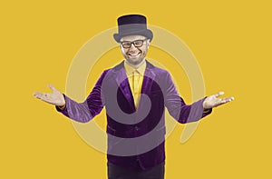 Smiling entertainer in suit and hat spreading his arms and welcoming you to circus show