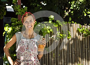 Smiling entrepreneur outisde her juice shop. Copy space