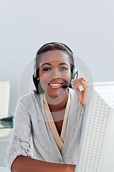 Smiling ethnic customer agent with headset on