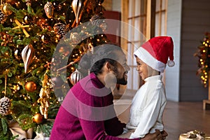 Smiling ethnic dad and son celebrate Christmas at home