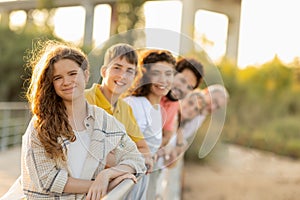 Smiling european multi-generation family have fun, enjoy walk, vacation in city park at weekend together