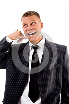 Smiling executive showing telephonic gesture