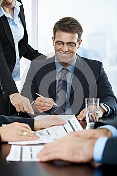 Smiling executive signing contract