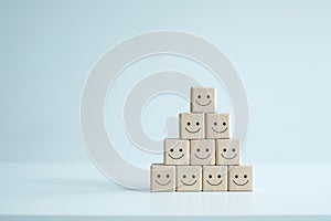 Smiling face icons on wooden cubes. Teamwork, Positive thinking, Feedback, Satisfaction concept.