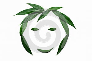 A smiling face, lined with green leaves. The concept of naturalness and love of nature.