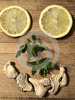 Smiling face made from lemon slices, parsley and dried ginger photo