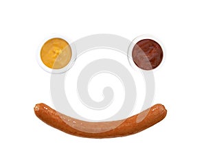 Smiling face from mustard with ketchup and sousage photo
