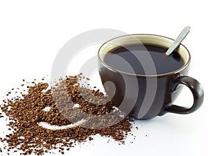 Smiling face shape drawing on soluble instant coffee powder and black coffee with silver spoon in dark brown ceramic cup