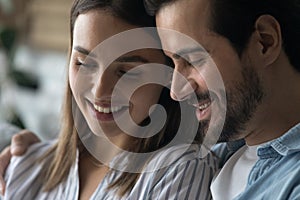 Smiling faces of romantic millennial couple sharing feelings emotions memories