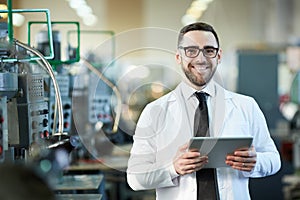 Smiling  Factory Worker  Holding  Tablet