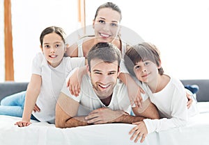 Smiling family in bed