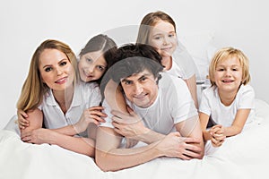 Smiling family in bed