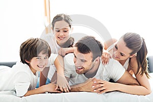 Smiling family in bed