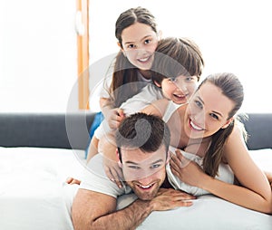 Smiling family in bed