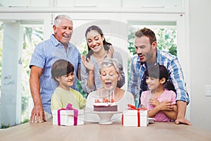 Smiling family during birthday party of granny
