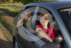 Smiling family with children in the car. Holiday and travel concept