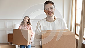 Smiling family couple moving in new apartment.