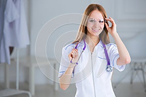 Smiling family doctor woman with stethoscope.