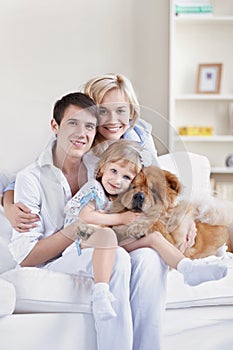 Smiling family with a dog