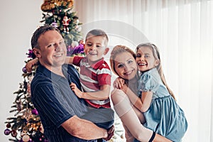 Smiling family of four at Christmas