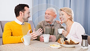 Smiling family having breakfast