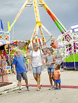 Smiling family having fun at an outdoor summer carnival