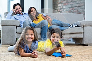 Smiling family in living room looking tv